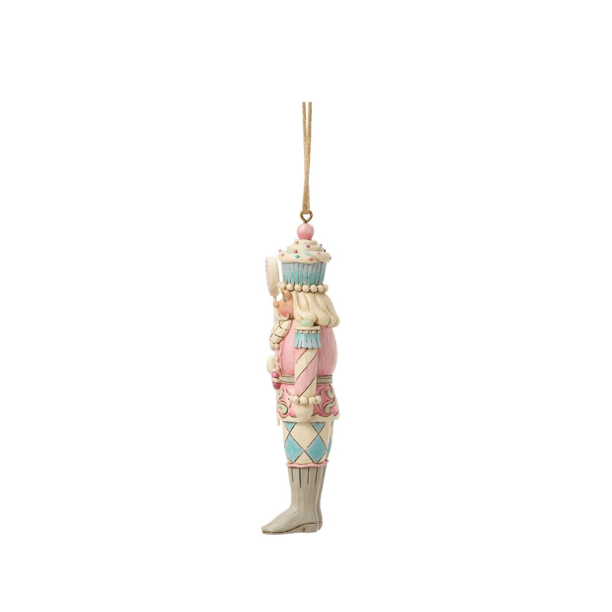 A playful twist on tradition, this toy soldier holds a bright candy lollipop and wears a cupcake helmet. Jim Shore's artistry transforms the disciplined officer into a whimsical holiday friend. Perfect for sweetening any Christmas display.
