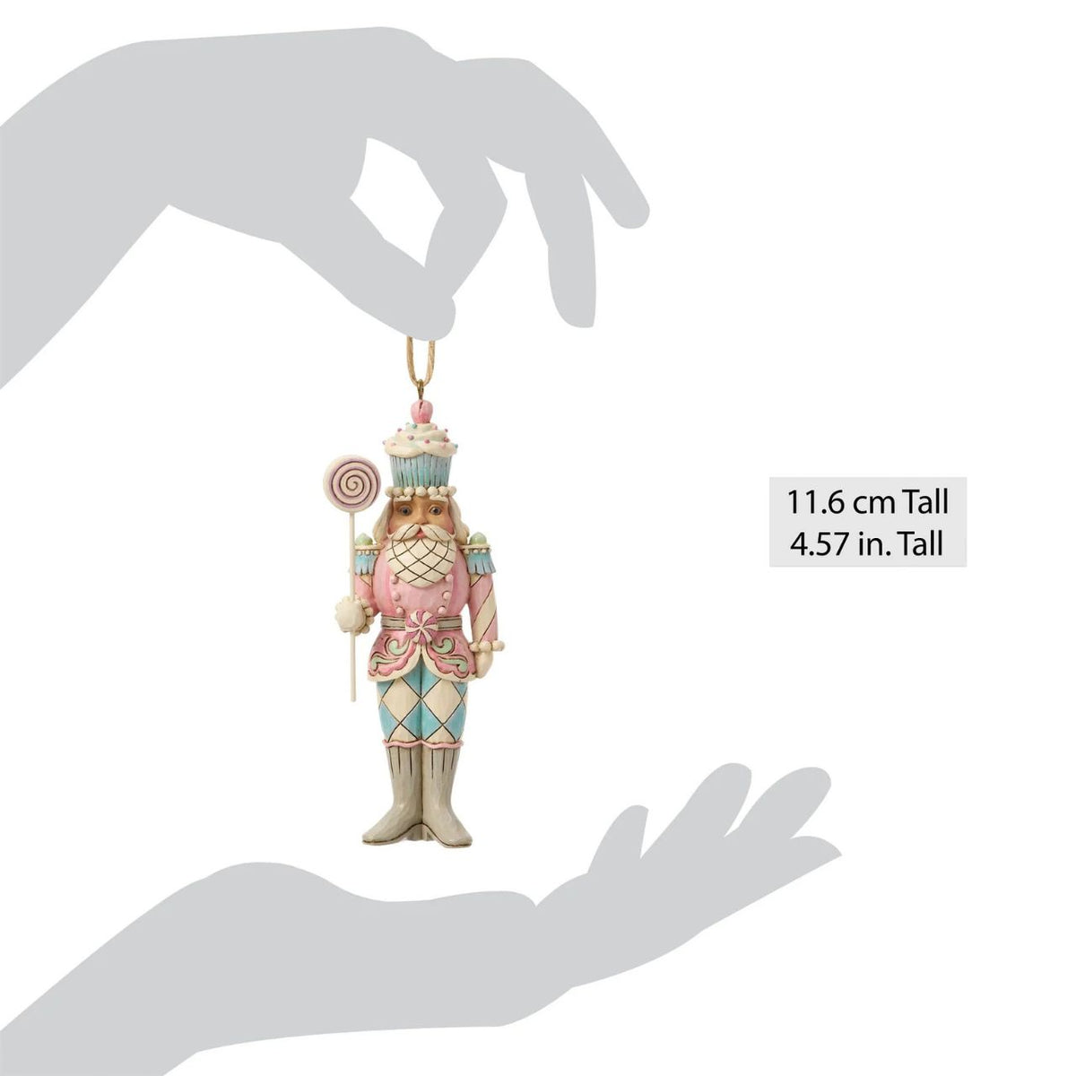 A playful twist on tradition, this toy soldier holds a bright candy lollipop and wears a cupcake helmet. Jim Shore's artistry transforms the disciplined officer into a whimsical holiday friend. Perfect for sweetening any Christmas display.