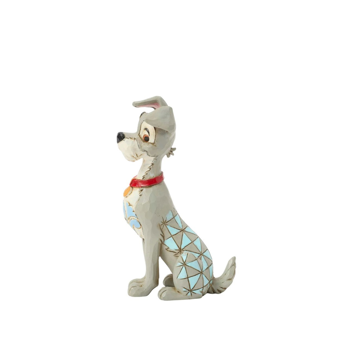Celebrate the 70th anniversary of Lady and the Tramp with this dashing Jim Shore rendition of the Tramp. Adorned with the artist's signature patchwork and rosemaling details, he sits astutely in his new collar, ready to embrace his life with Lady.