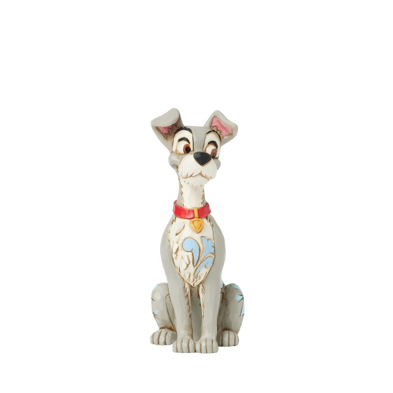 Celebrate the 70th anniversary of Lady and the Tramp with this dashing Jim Shore rendition of the Tramp. Adorned with the artist's signature patchwork and rosemaling details, he sits astutely in his new collar, ready to embrace his life with Lady.