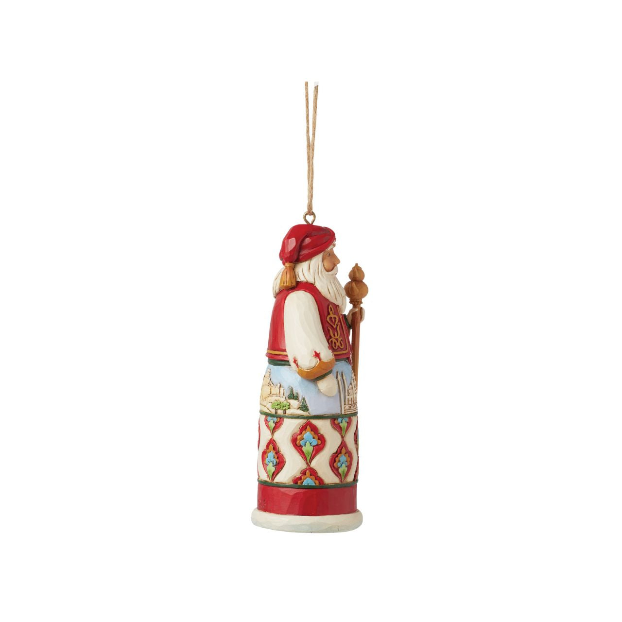 Jim Shore's Christmas Around the World collection celebrates tradition and culture. Incorporating each country's unique customs, this Turkish Santa ornament wears traditional robes with famous architecture, a red turban, and ornate designs.