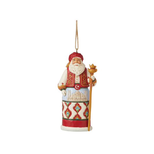 Jim Shore's Christmas Around the World collection celebrates tradition and culture. Incorporating each country's unique customs, this Turkish Santa ornament wears traditional robes with famous architecture, a red turban, and ornate designs.
