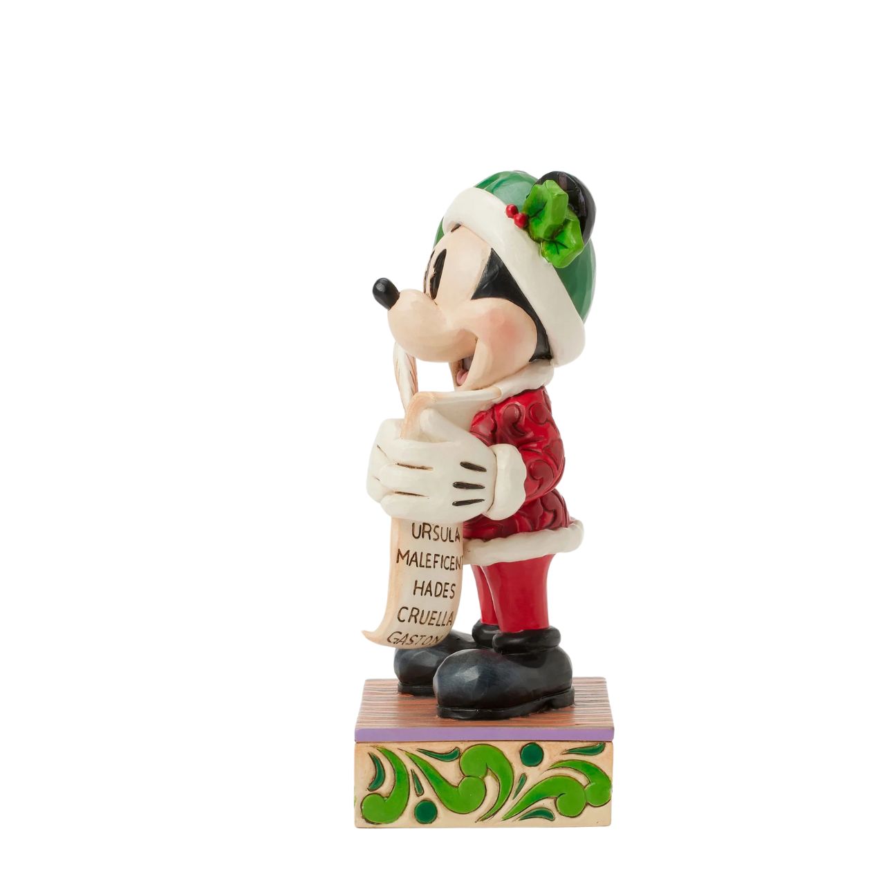 In this enchanting Jim Shore Christmas scene, Mickey Mouse dons a striking red rosemaling suit accented with a green jewelled belt and a Santa hat trimmed with holly. He holds a quill and a list of Naughty and Nice Disney characters with a smile.