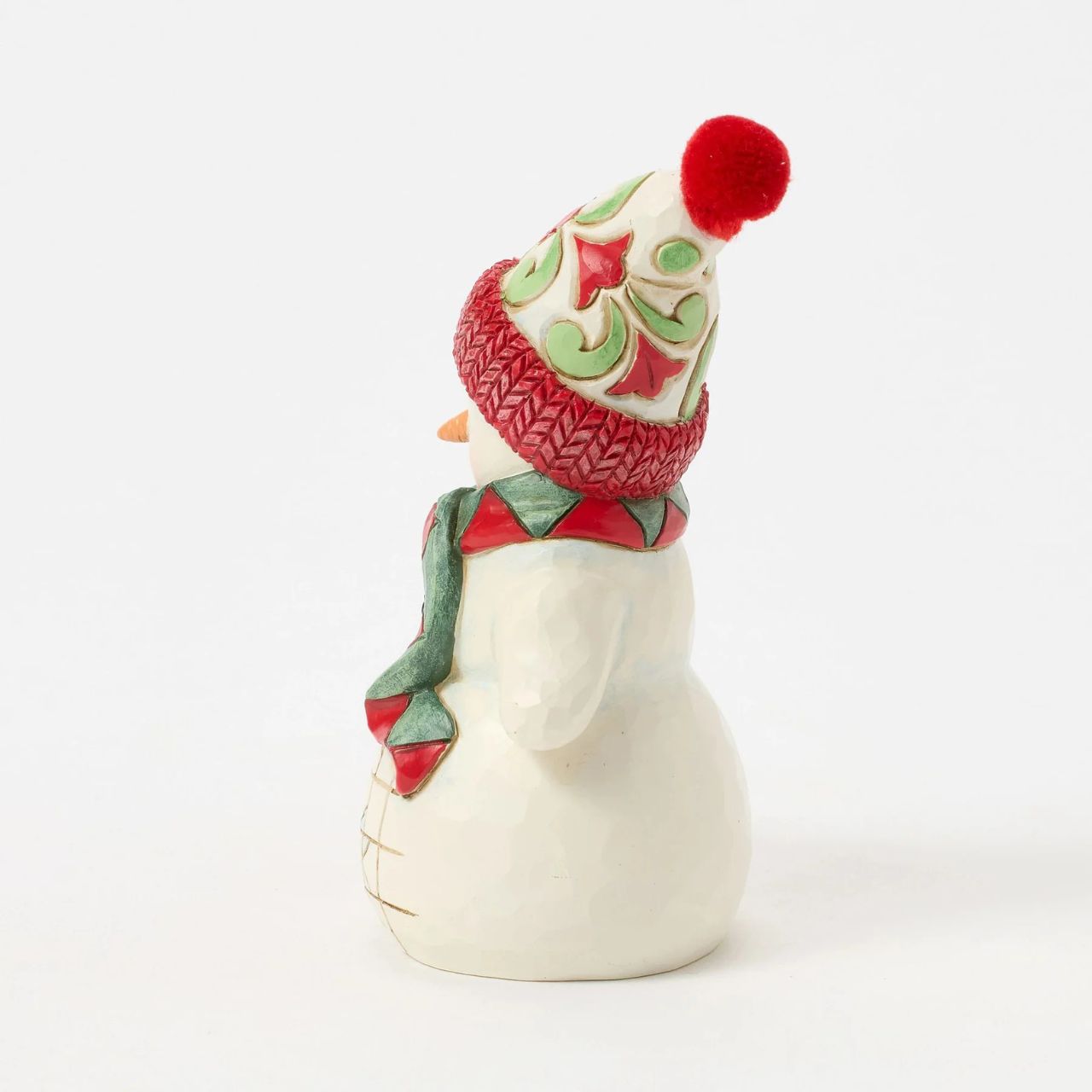 This charming Jim Shore pint snowman brings holiday joy with a playful scene of a curious puppy tugging at his scarf. Wearing a vibrant floral knit cap, the snowman smiles warmly, capturing the spirit of fun and friendship in wintertime.