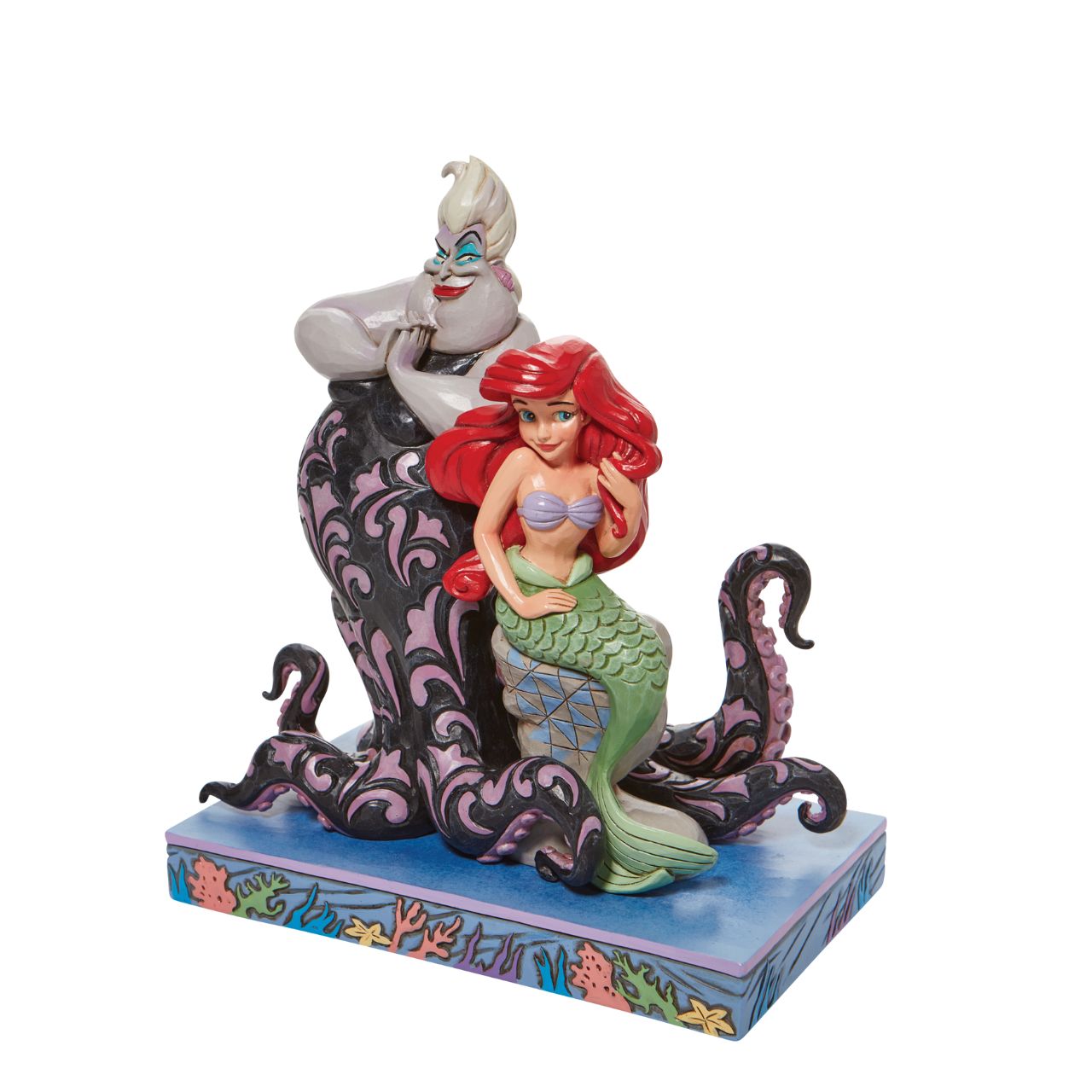 This Jim Shore piece ventures under the sea to share a scene of good and evil. Smiling innocently, Ariel, the little mermaid, sits on a stump as the sea witch, Ursula, connives cruelly behind her shoulder. Packaged in a branded gift box.