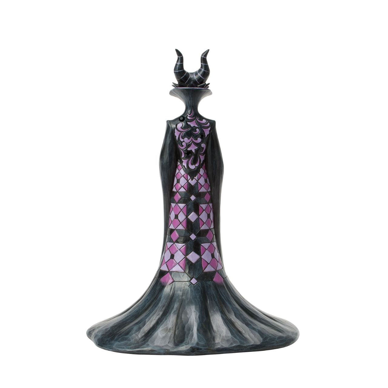 This Jim Shore design captures the vengeful villainess, Maleficent, in her striking black and purple cloak adorned with Shore's quilt and rosemaling patterns. With a sinister gaze, she taps her staff, channeling dark magic with malice in her heart.