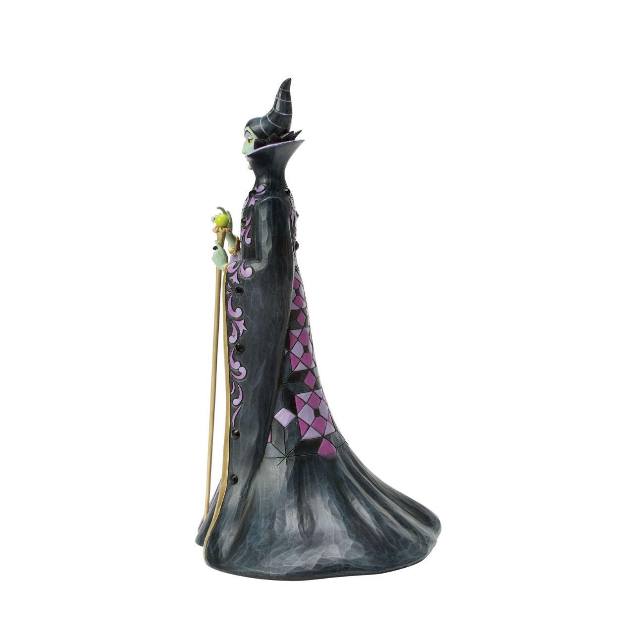 This Jim Shore design captures the vengeful villainess, Maleficent, in her striking black and purple cloak adorned with Shore's quilt and rosemaling patterns. With a sinister gaze, she taps her staff, channeling dark magic with malice in her heart.