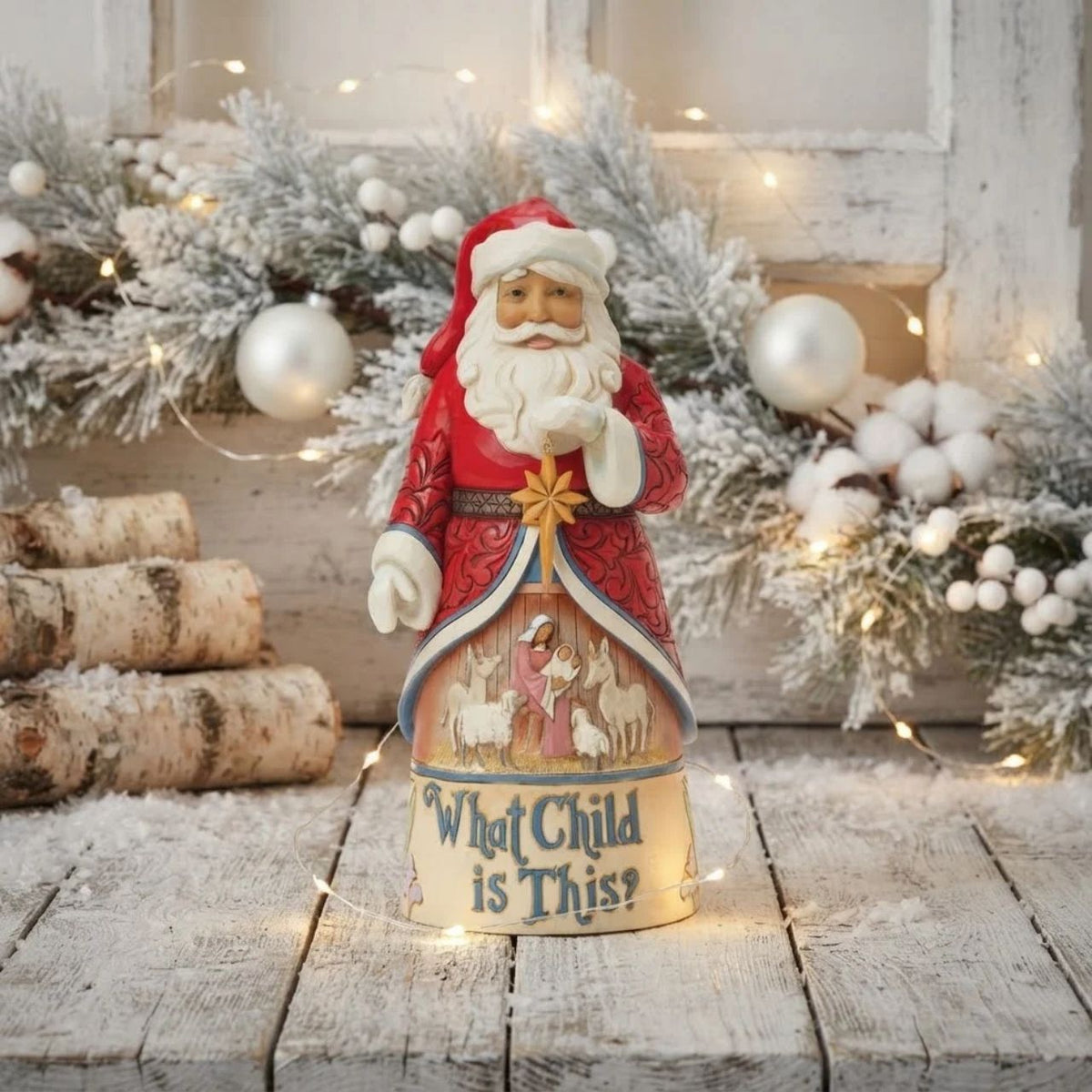 From the Santa Song Series this enchanting Jim Shore Santa beams as he holds the Christmas star, his intricate cloak parting to reveal a serene manger scene of Mary and Jesus with animals. Scripted "What Child is This.