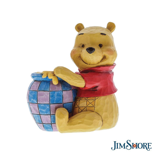 Jim Shore's Winnie the Pooh with Honey Pot  Beautifully handcrafted with delightful attention to detail, Jim Shore's charming miniatures capture the essence of the beloved Disney characters. A smiling Winnie the Pooh hugs his jar of honey in this classic moment inspired by the classic film.