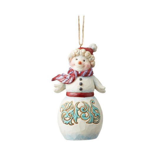 Heartwood Creek Winter Wonderland Snowman Hanging Ornament  Jim Shore's Winter Wonderland collection features a subtle glitter finish with Jim's signature colour and intricate design. This whimsical holiday Snowman ornament with knit cap and scarf is strikingly decorated with a bold blue rosemaling motif.