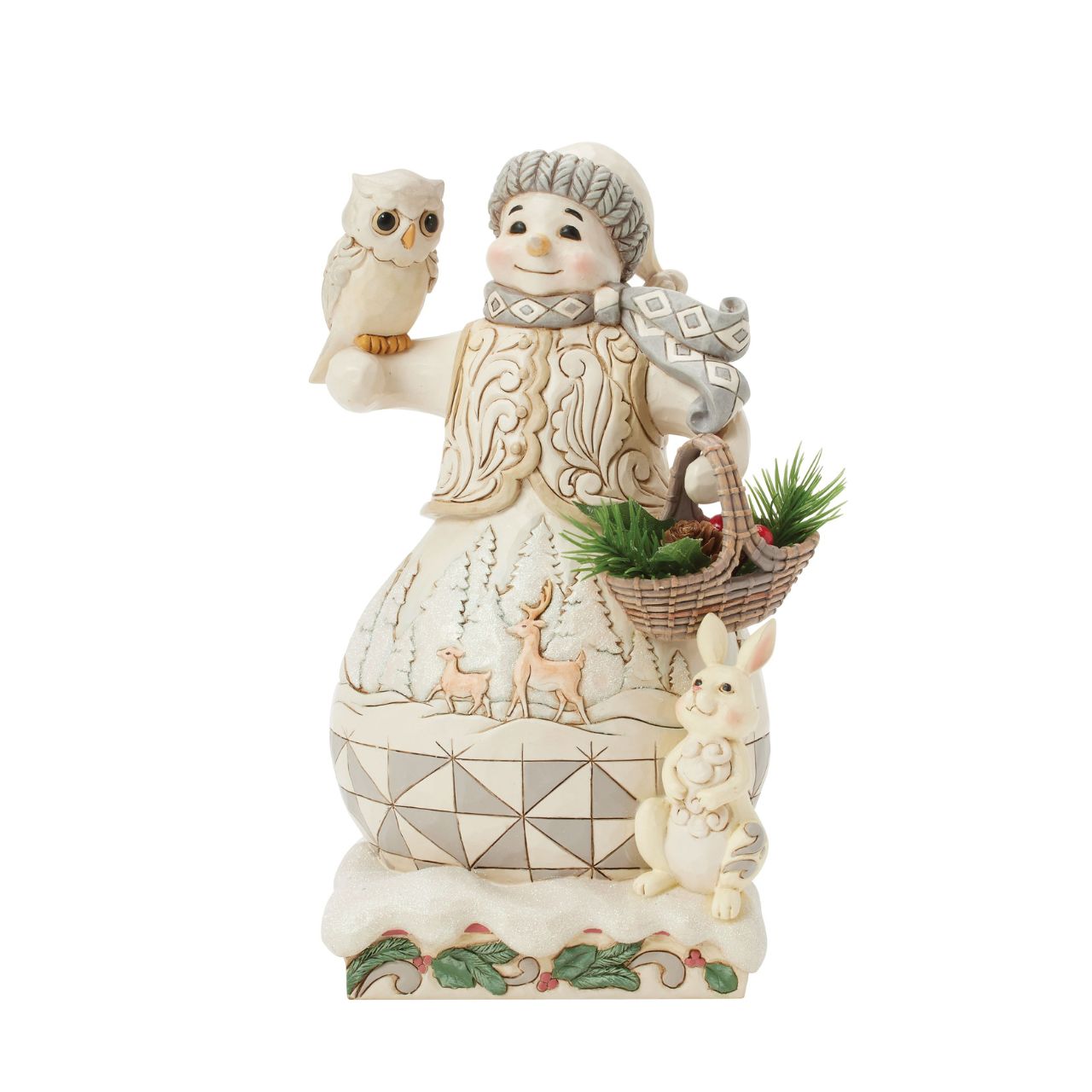 This enchanting Jim Shore White Woodland design features a charming snowman collecting evergreen sprigs in a basket, accompanied by a wise owl and a rabbit as he strolls through the serene forest. A deer scene is showcased on beneath his regal vest.