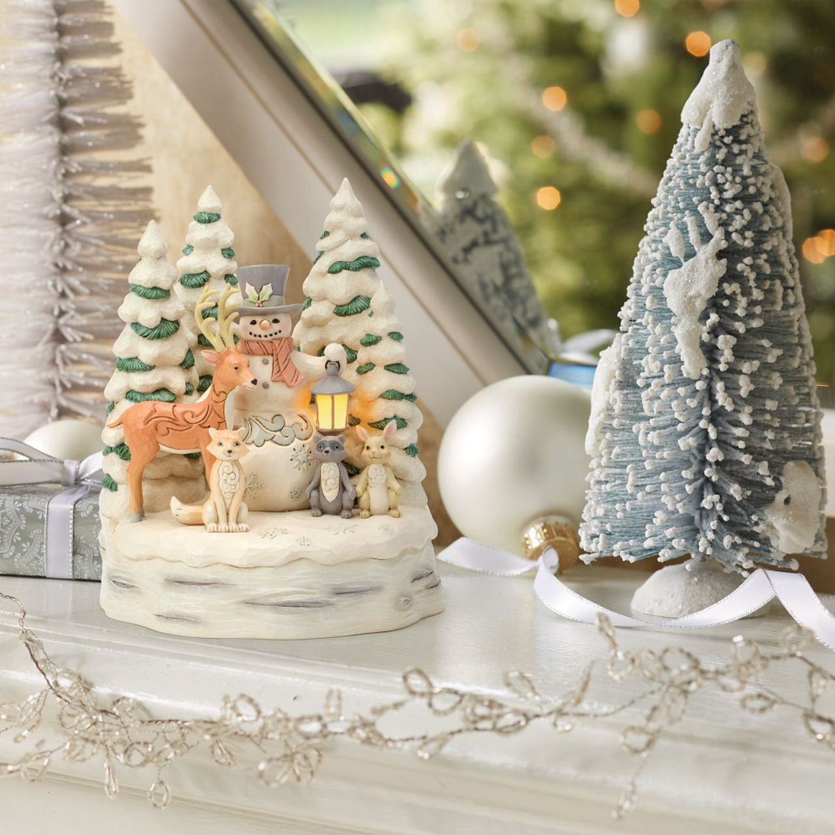 Embrace the peaceful beauty of winter with this enchanting LED snowman from Jim Shore's White Woodland collection.