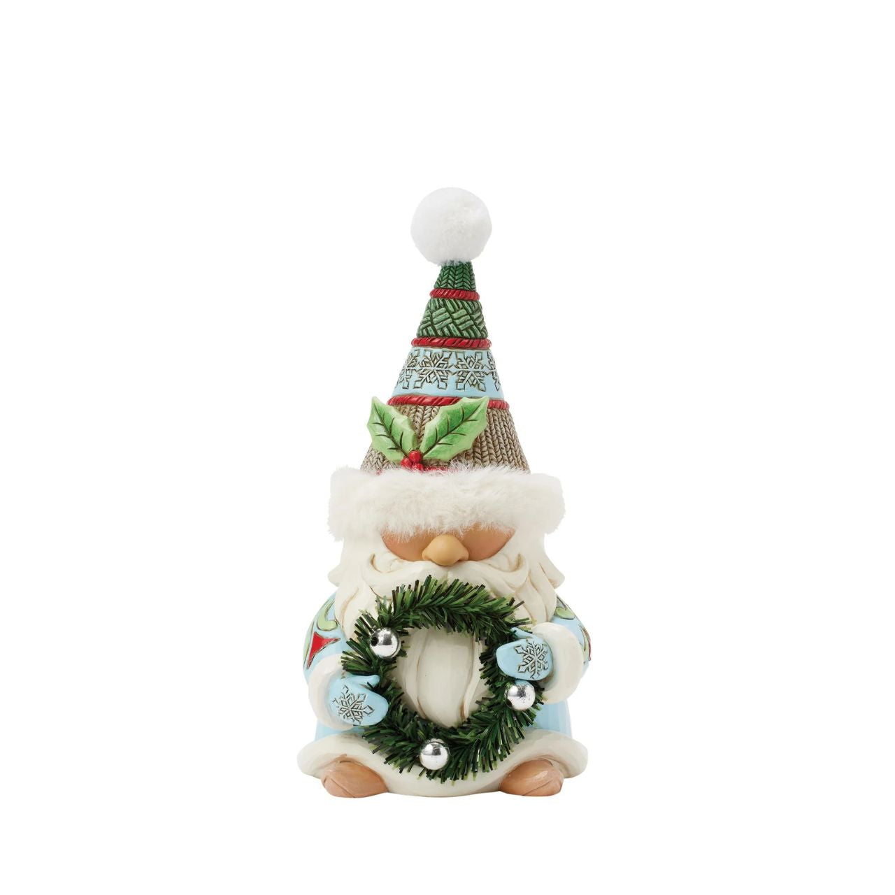 This festive Jim Shore gnome embodies holiday charm with a cozy hat with faux fur trim, intricate rosemaling, and snowflake patterns. Carrying a beautifully decorated wreath, he exudes warmth and joy bringing the spirit of Christmas to any space.