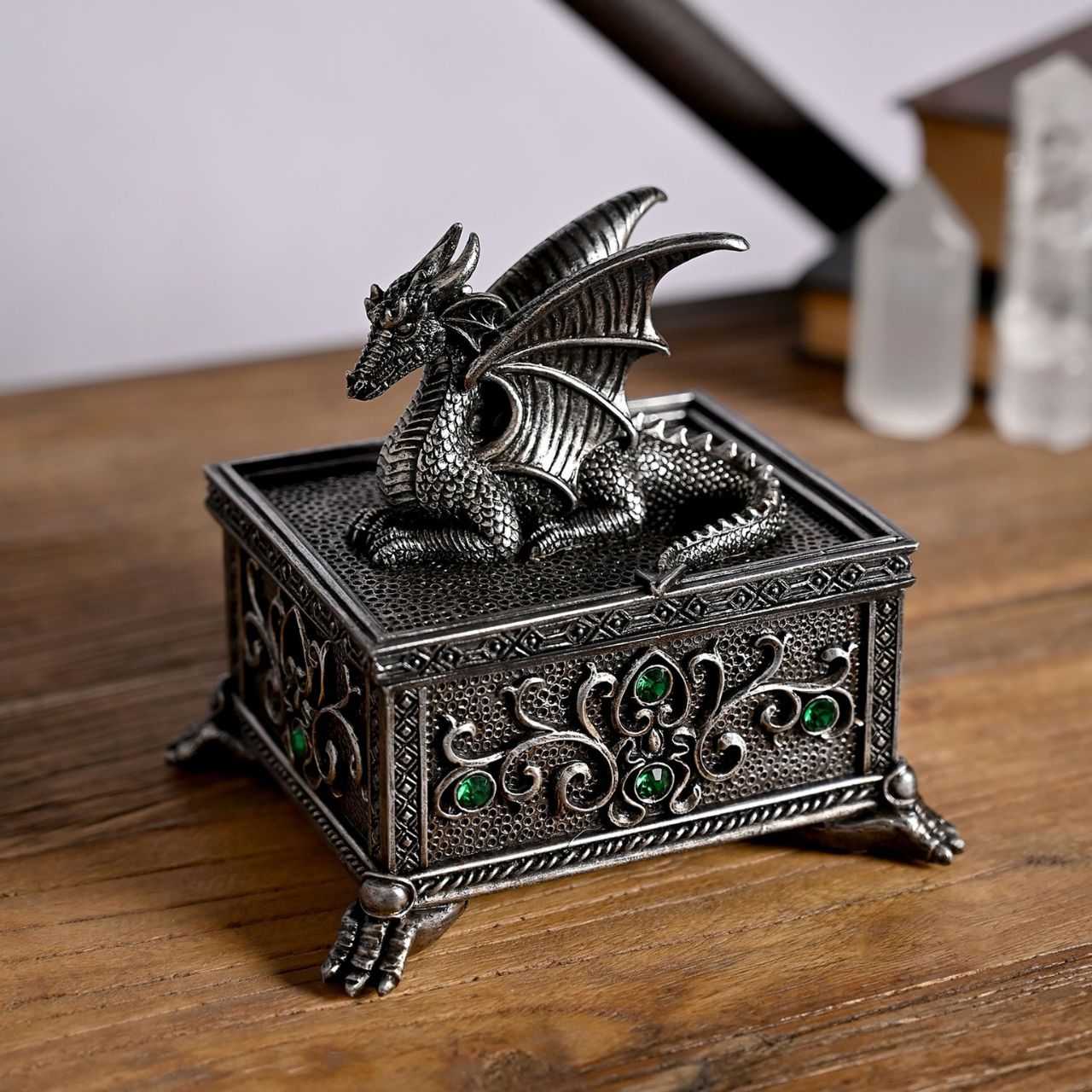 This silver coloured item with green crystals, is made from high-quality resin allowing for intricate detailing. A brand for customers and avid collectors who are drawn to the mystical and gothic aesthetic.