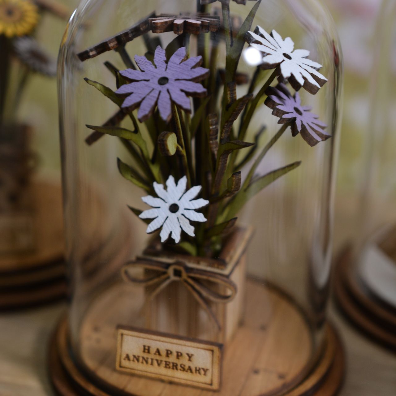 Celebrate an anniversary with this beautiful floral gift. This eco-friendly glass dome decoration encases a bunch of stunning purple and white flowers, adorned with a Happy Anniversary plaque. 
