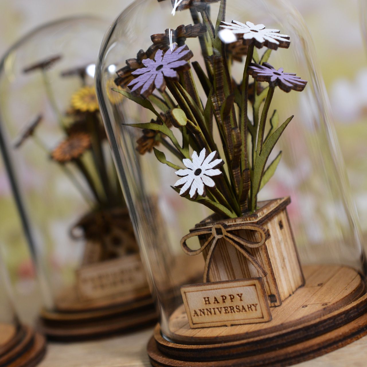 Celebrate an anniversary with this beautiful floral gift. This eco-friendly glass dome decoration encases a bunch of stunning purple and white flowers, adorned with a Happy Anniversary plaque. 