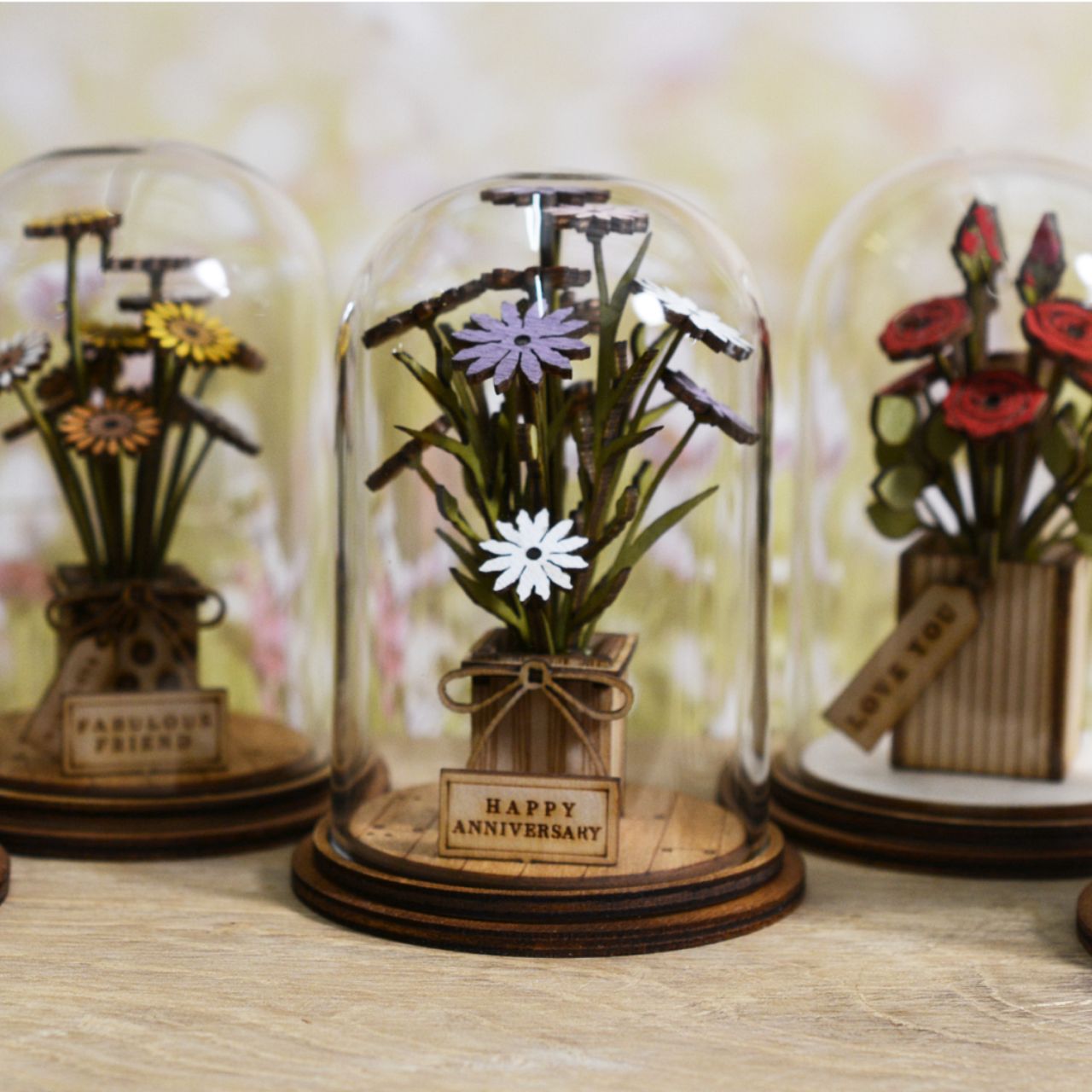 Celebrate an anniversary with this beautiful floral gift. This eco-friendly glass dome decoration encases a bunch of stunning purple and white flowers, adorned with a Happy Anniversary plaque. 