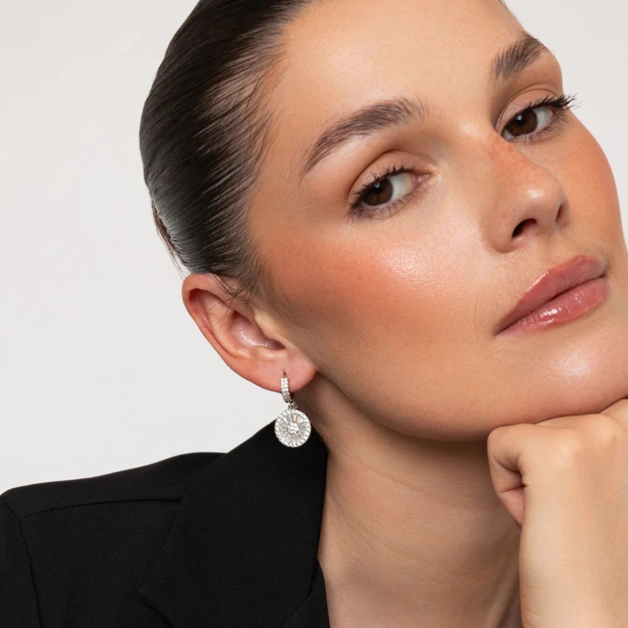 Elevate your elegance with the Knight & Day Crystal Disc Earrings. These exquisite disc drops are intricately adorned with sparkling CZ stones, offering a refined shimmer that catches the light beautifully.