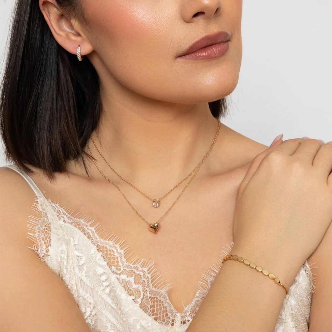 Upgrade your accessory game with Knight & Day's Gold Huggies Earrings. Crafted from gold plated, these earrings add a touch of elegance to any outfit. Featuring a comfortable and secure huggie design, these earrings are perfect for everyday wear. Elevate your style with Knight & Day.