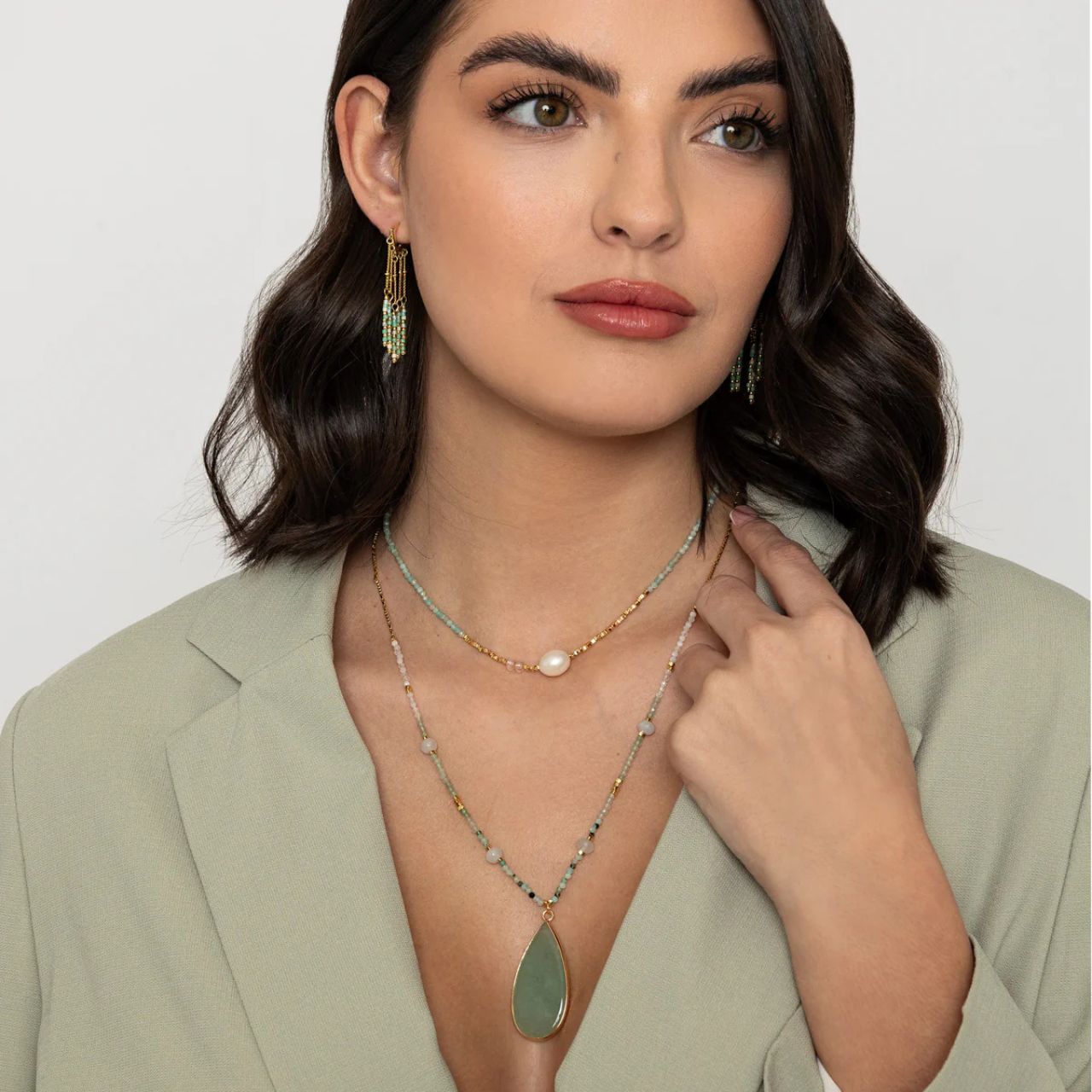 Long, semi precious stone necklace with mix of moonstone, gold & green stone beads & centre piece of green aventurine. Length 70cm. Gold plating.