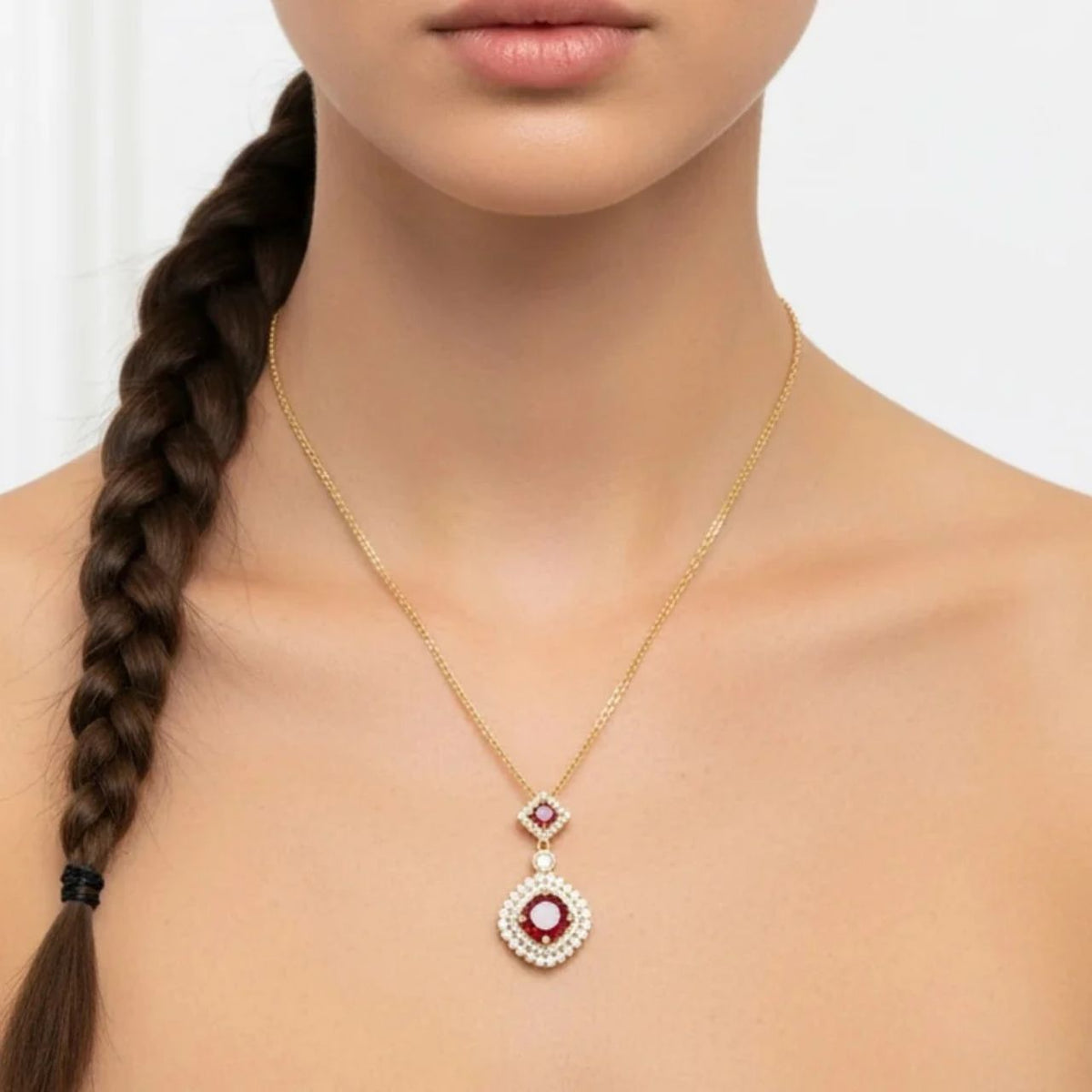 Vintage-inspired double drop pendant featuring stunning deep garnet crystals set among sparkling cubic zirconia stones.