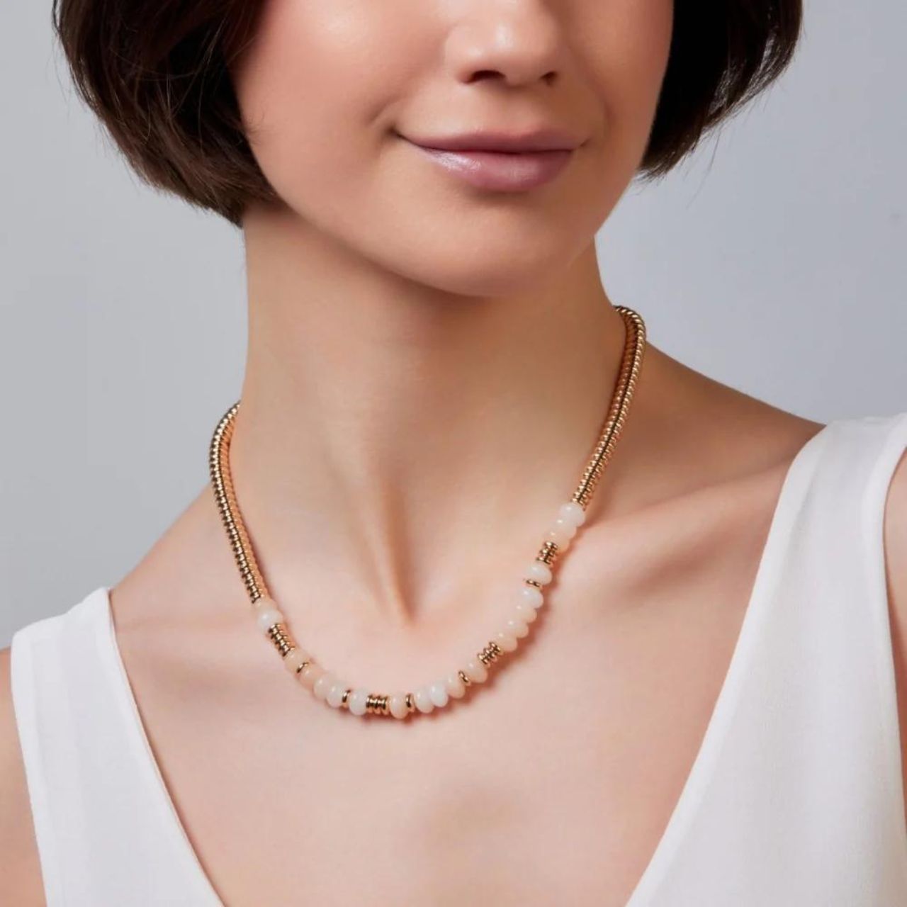 Maleah Beige & Gold Necklace by Knight & Day  Add a pop of elegance to your wardrobe with the Knight & Day Maleah Beige & Yellow Gold Bead Necklace. Expertly crafted from beige and gold beads, this stylish necklace lets you express your unique sense of style. Suitable for both formal and casual occasions, this necklace is sure to become a go-to favourite.
