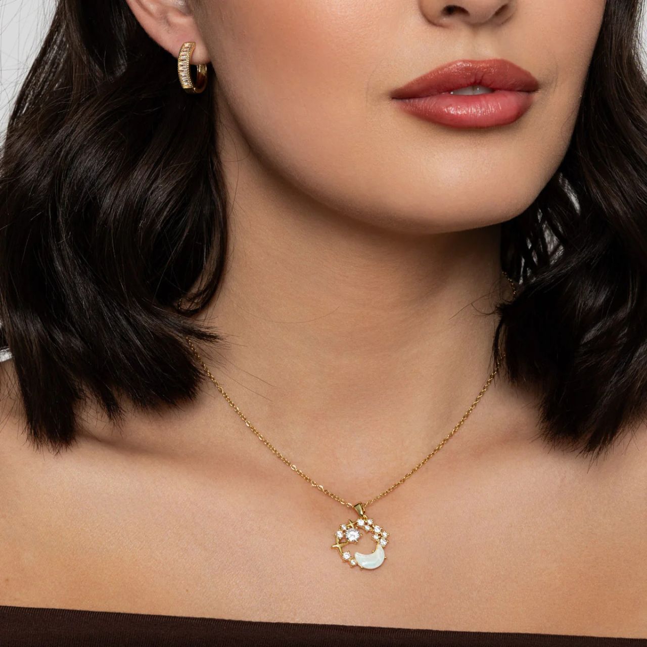 Beautiful white glass moon shape embellished with CZ stones. Length 41 + 5cm extension. Gold plating.