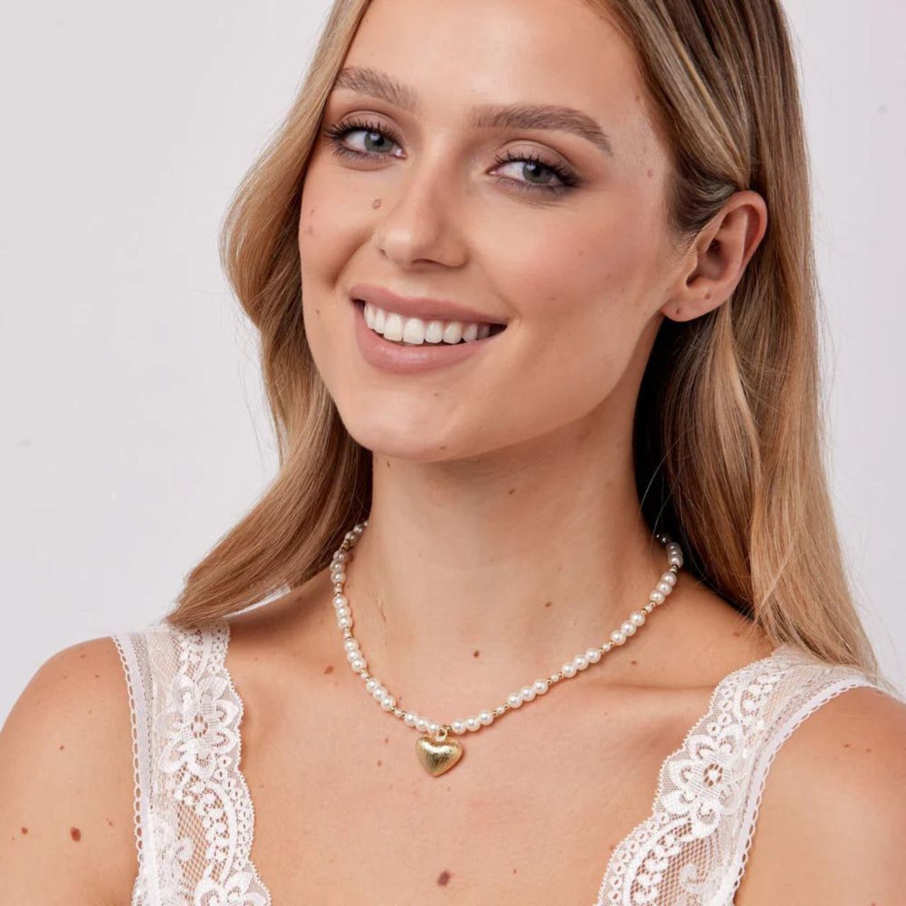Indulge in luxury with Knight &amp; Day's Gold Plated Pearl &amp; Heart Necklace. Made with the finest materials, this necklace features a stunning pearl and heart design that will elevate any outfit. Upgrade your jewellery collection with this elegant piece.