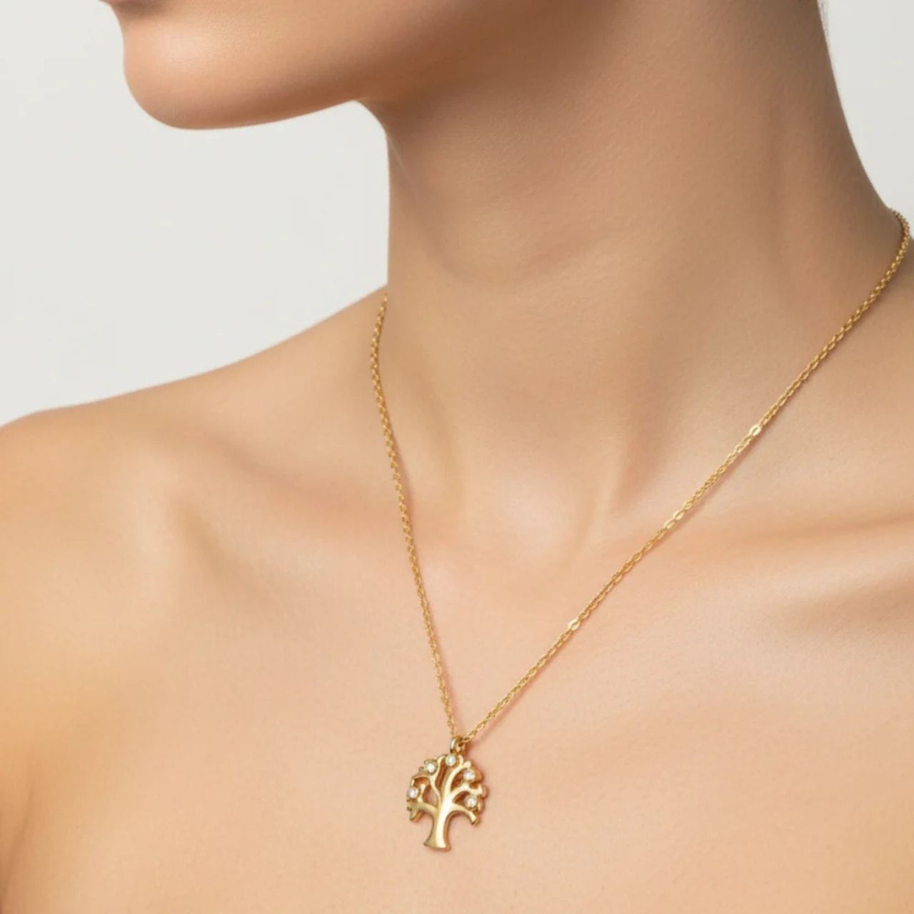 Beautiful Tree of Life pendant embellished with CZ stones. Length 16" + 2" extension. 18k gold plated.