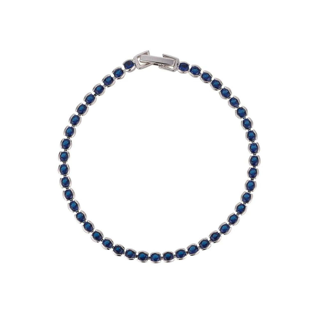 Dakota Sapphire Tennis Bracelet by Knight & Day  Miniature rhodium plated tennis bracelet with Sapphire CZ stones. Elegant when worn alone and ideal for layering with watch or other bracelets. Fold over clip fastening.
