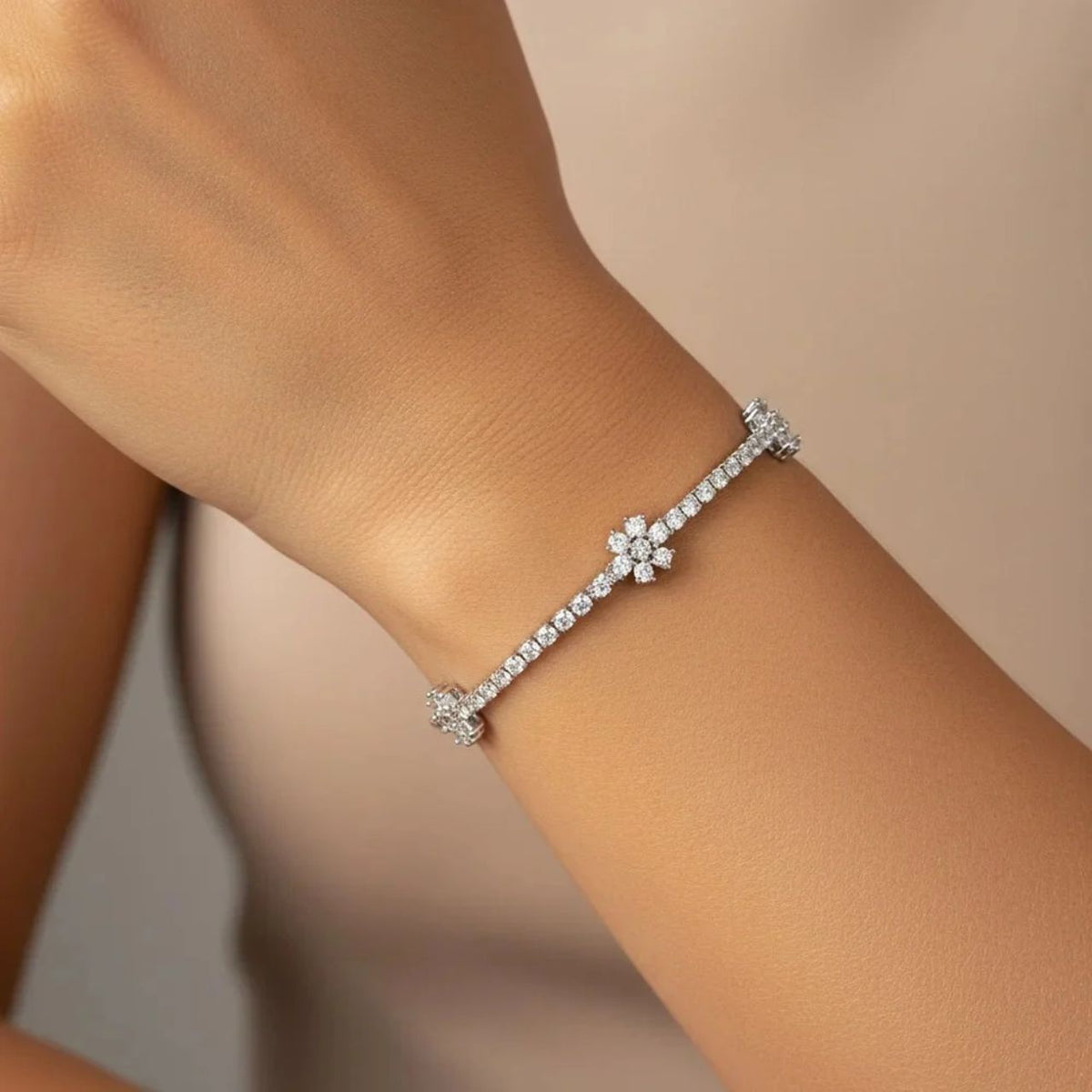 Delicate and pretty tennis bracelet with tiny CZ stones embellished with 3 beautiful floral shapes. Rhodium plating. Length 18cm with optional 2cm extension. Fold over clip fastening.