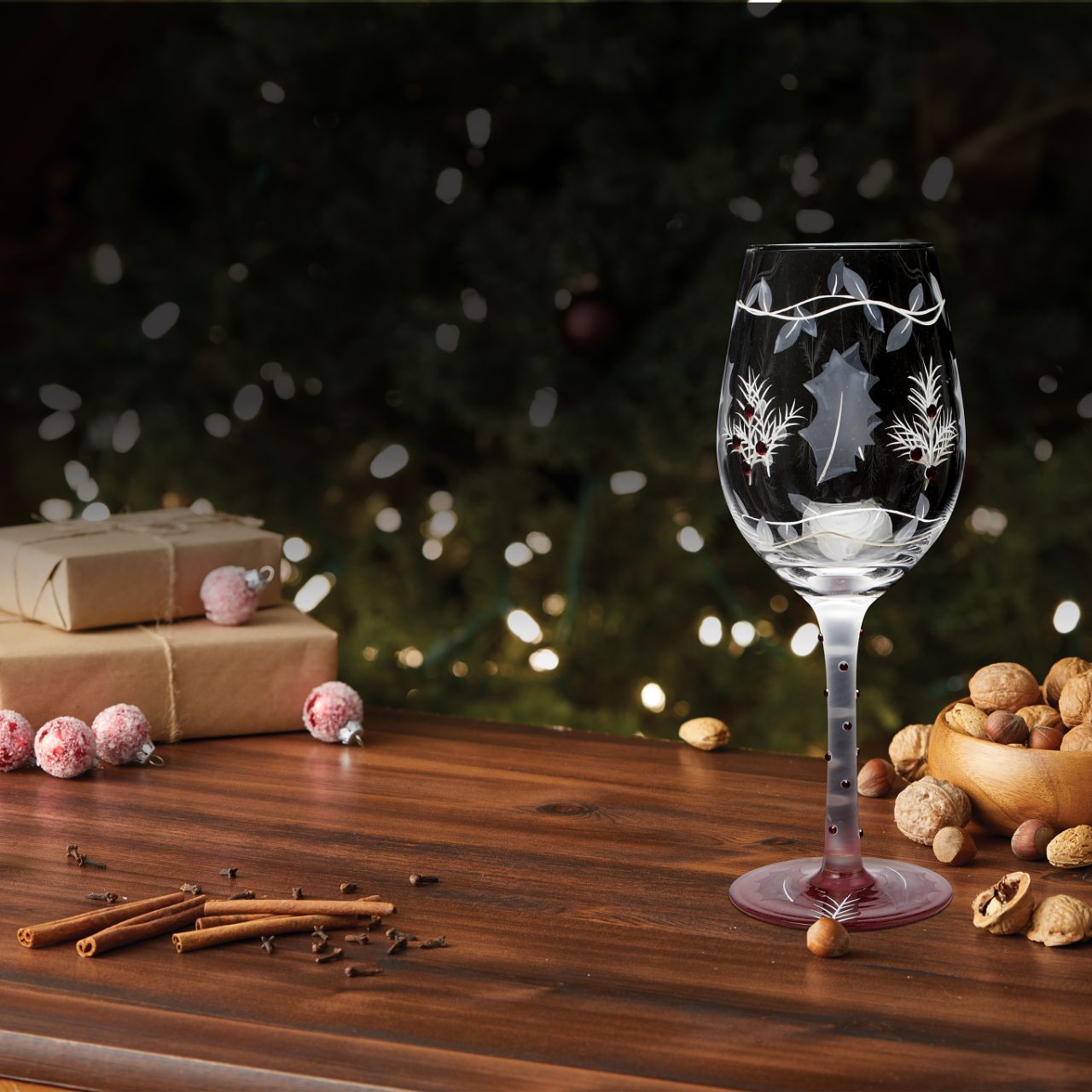 This lovely frosted wine glass enchants with a lightly painted winter forest scene. Encircled with vines and embossed holly leaves, this nature inspired cup enchants with inlaid red crystals and delicate stencilling. Have a Merry Berry Christmas.