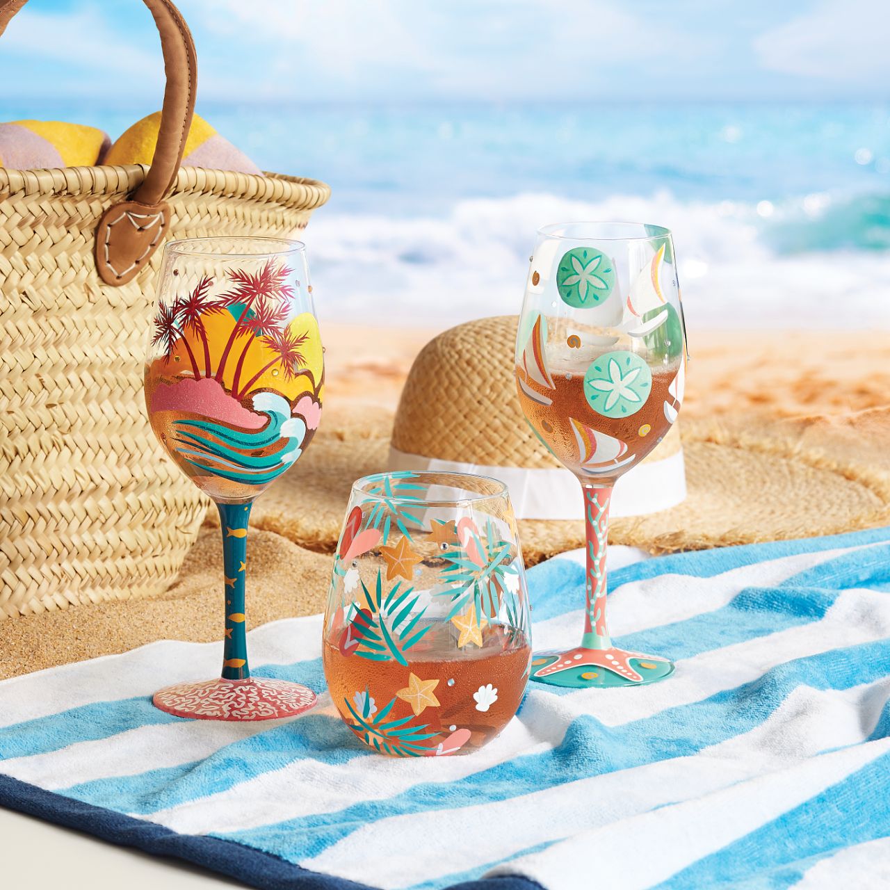 Stroll in the sand, splash through the water and lay back on your sunbed as you enjoy your favourite drinks from the Beachful Bliss Stemless Glass by Lolita. Hand-painted golden starfish, stylised palm leaves, delicate seashells and coral flip flops dance around the bowl of the glass in a symphony of summertime motifs.