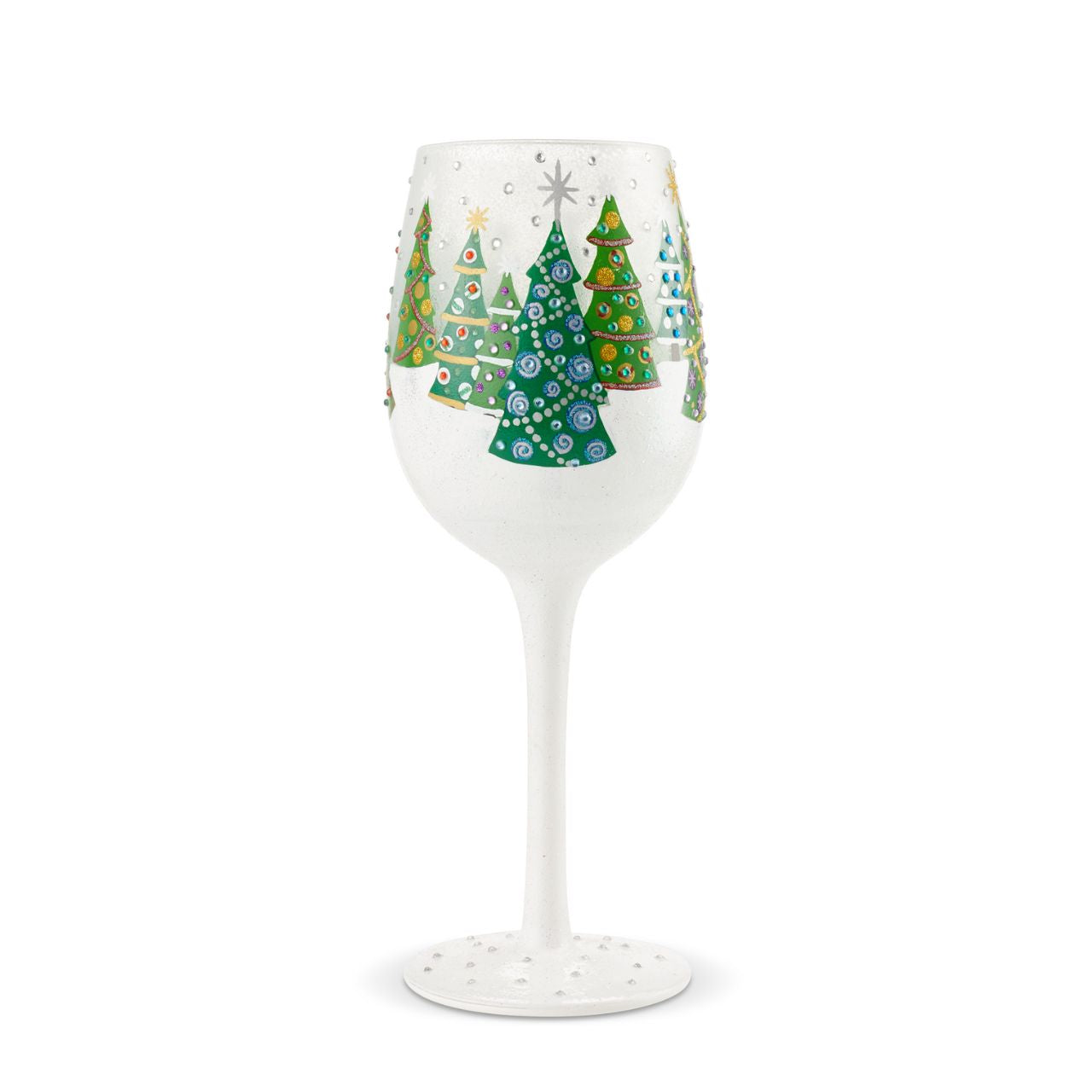 Christmas Trees in the Snow Wine Glass by Lolita  Christmas pines covered in lights and ornaments cover this winter wonderland wine glass. With textured snow and glittering accents, this wine glass is ready for wassail and snowflakes.