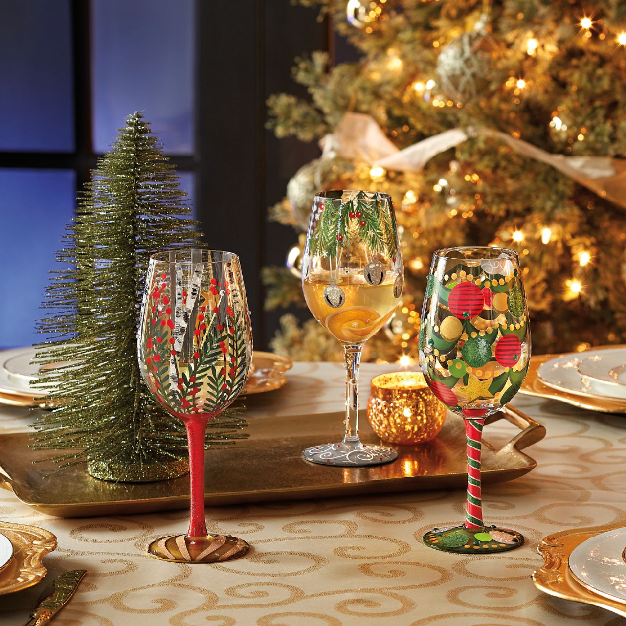 Visions of Christmas Birch Wine Glass by Lolita   Take a Christmas walk with our Visions of Birch Wine Glass by Lolita. Surrounded by beautifully decorated Christmas branches, a full red glittered stem and a gold Christmas bauble on the bottom of the glass this wine glass radiates Christmas all year round.