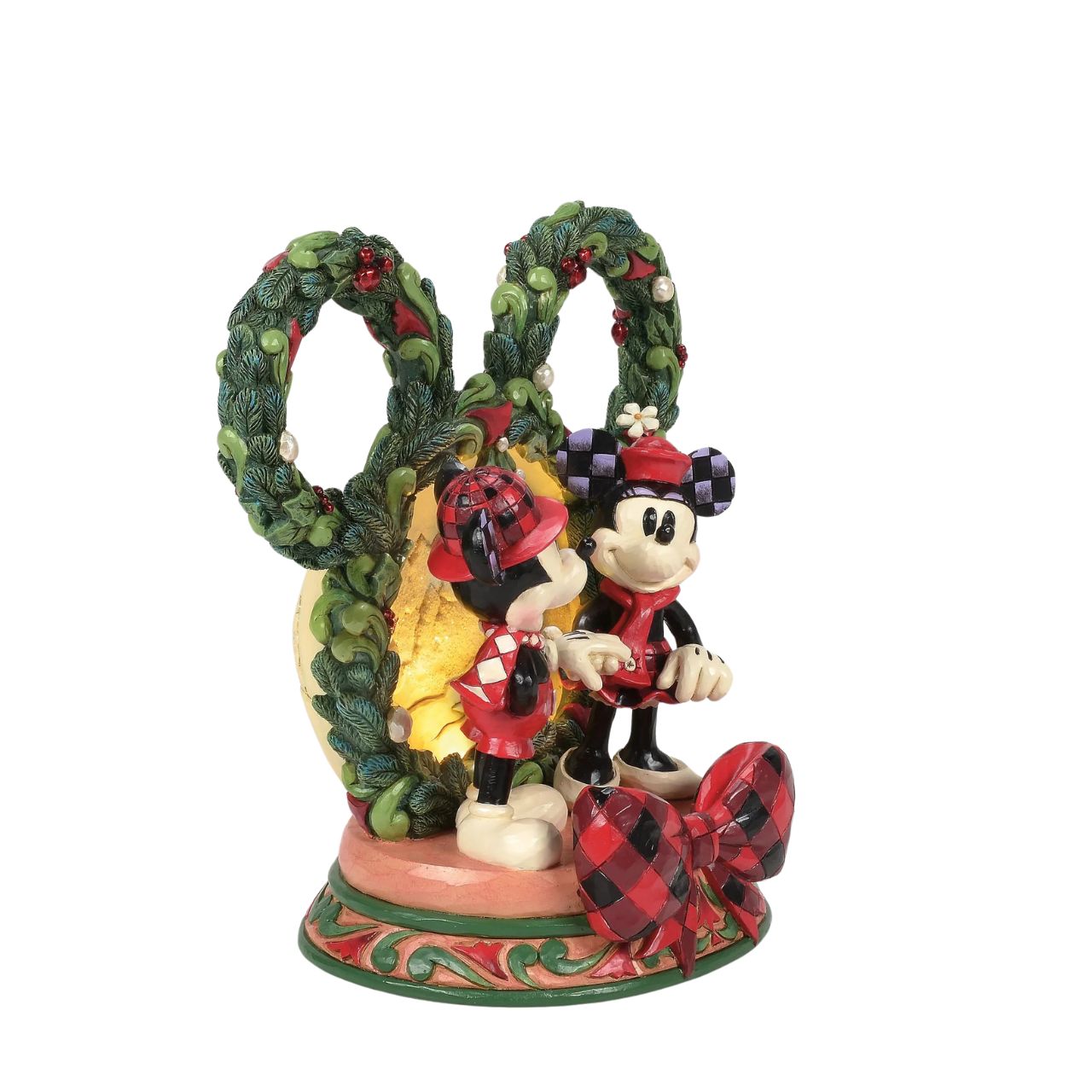 This delightful Jim Shore Christmas scene captures Mickey and Minnie holding hands beneath a glowing LED diorama, framed by a festive Mickey-shaped garland adorned with berries and pearl accents. It radiates seasonal magic with holiday charm.