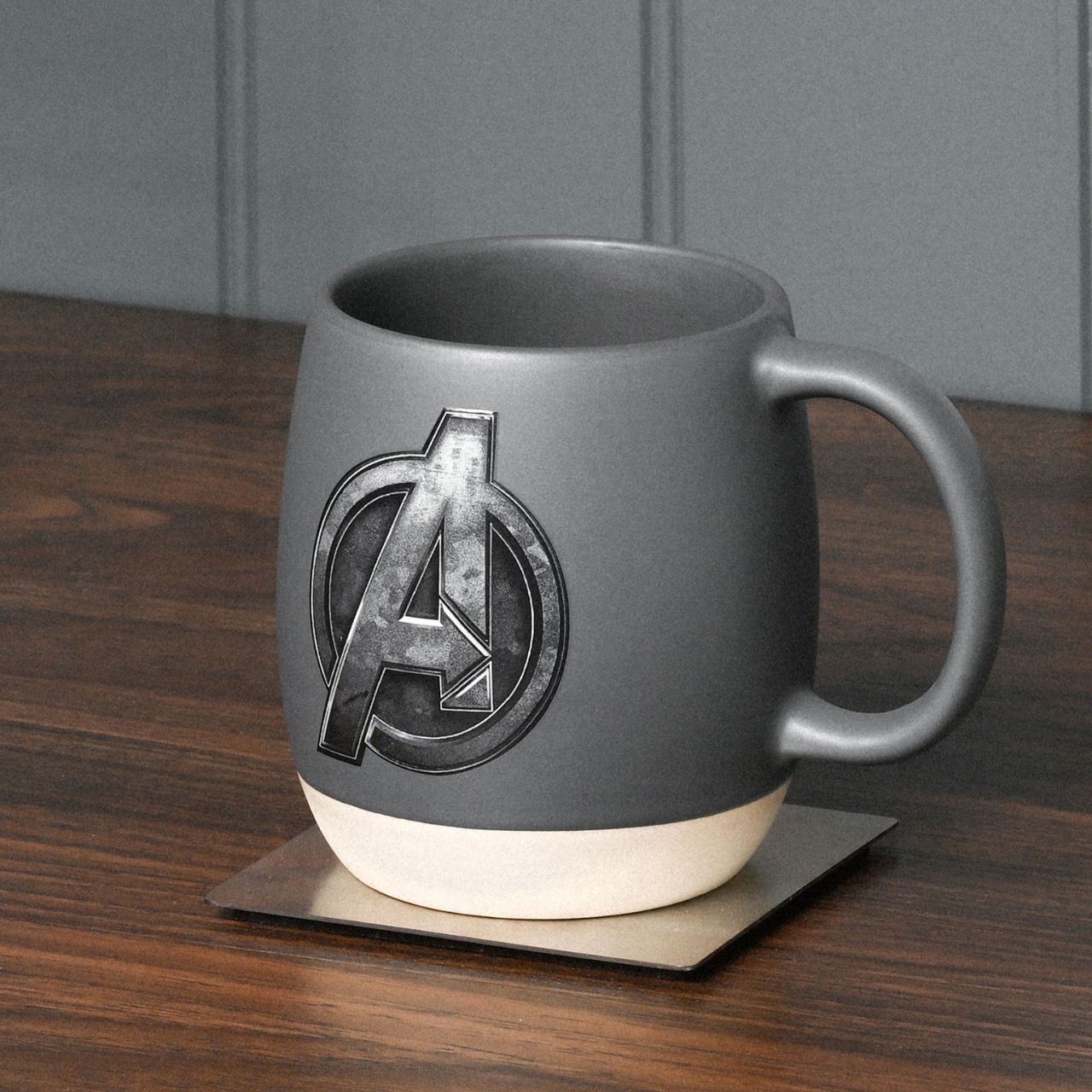Unleash your inner superhero with the Marvel The Avengers Mug. This striking gray ceramic mug, featuring an embossed Avengers logo, is a must-have for any Marvel enthusiast. Perfect for sipping your morning brew, it's a delightful way to add a touch of fandom to your day.