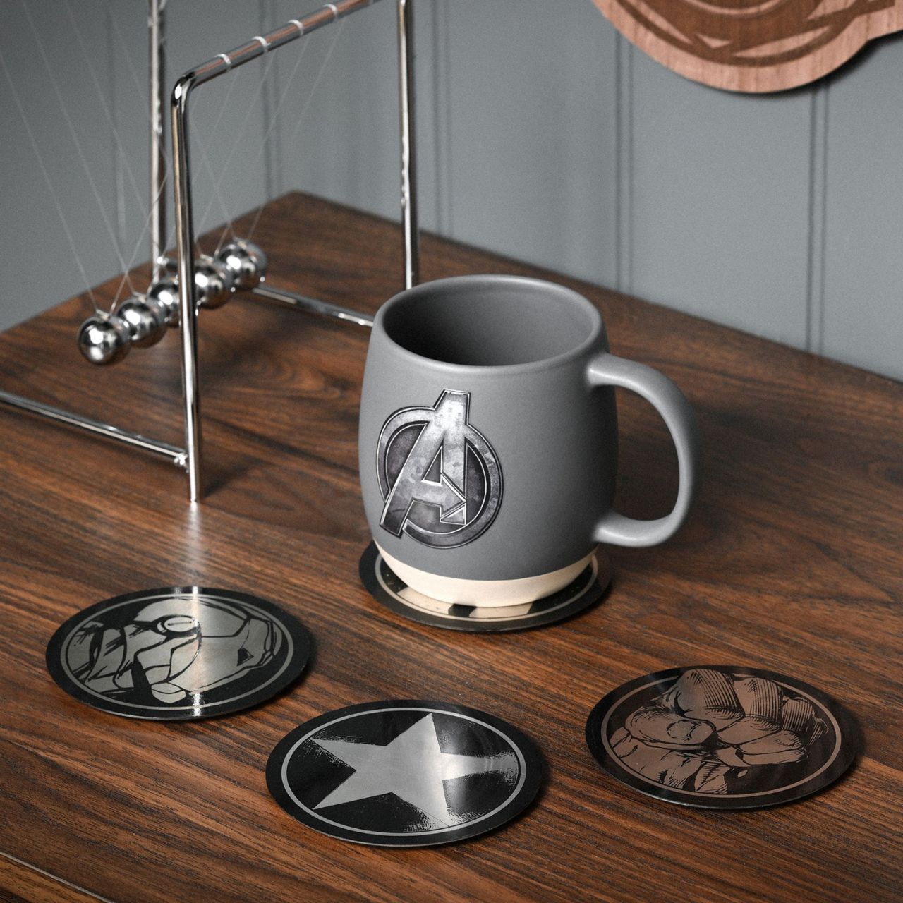 Unleash your inner superhero with our Marvel The Avengers Set of 4 Black Round Metal Coasters. Each coaster features a striking abstract design, including symbolic representations of your favourite Avengers' powers, all in a bold black and silver colour scheme.