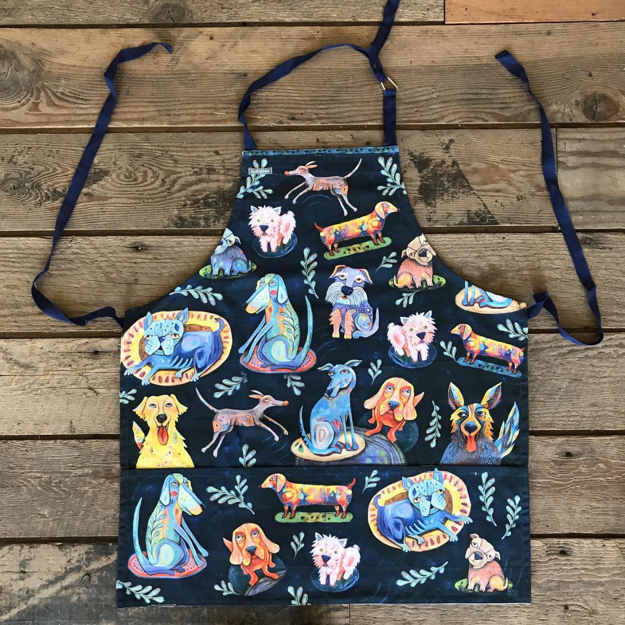 Kids Dog Park Apron by Allen Design  The kids in your life are going to love having an apron that was made just for them. This Dog Park apron is made of durable cotton canvas, and is perfect for crafting, gardening, helping out in the kitchen, or just looking like the coolest kid in the house. Exclusively designed by Michelle Allen.