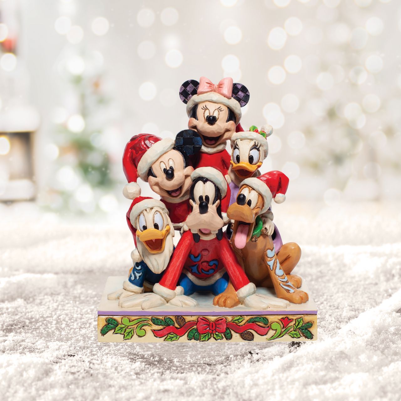 Christmas Mickey and Friends Stacked Figurine  Stacked in a holiday pyramid, Mickey and pals savour a day in the snow. Each wearing a Santa hat, they've discovered the meaning of Christmas and enjoy jolly laughs surrounded by friends.