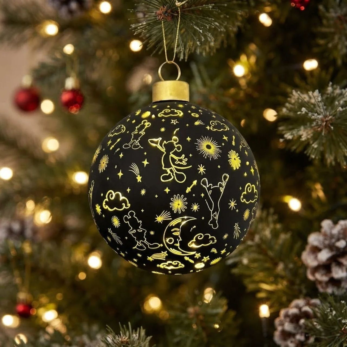 Bring festive magic to your tree with this enchanting Disney Mickey Mouse Galaxy Christmas Bauble. Featuring the beloved character set against a mesmerizing galaxy backdrop, this ornament showcases elegant black and gold detailing that adds timeless sophistication to any holiday display.