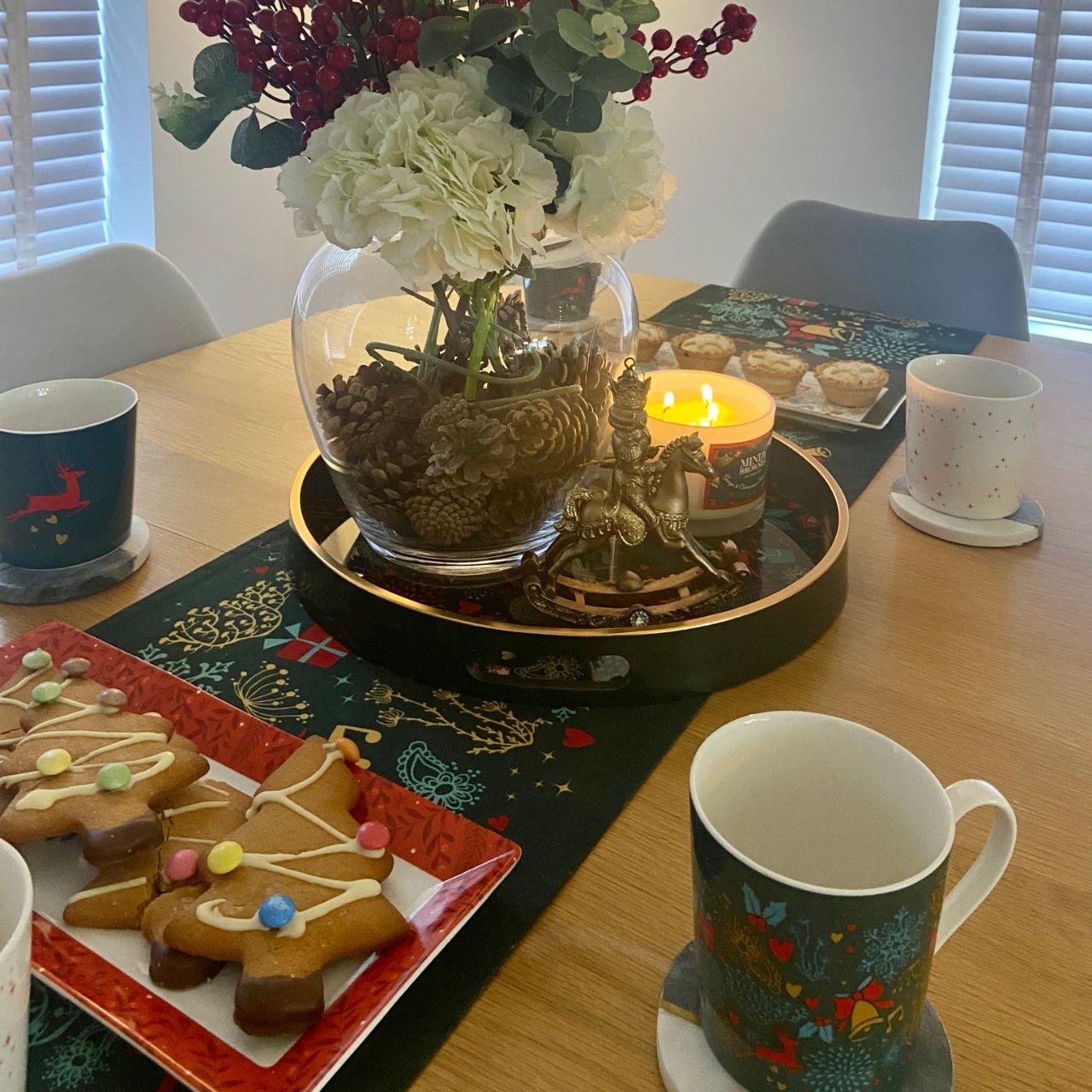 Christmas Wish Table Runner by Mindy Brownes Interiors  A beautiful table runner finished in forest green with a Christmas design that depicts some of Christmas' key elements, such as reindeer, presents, music notes, and more.