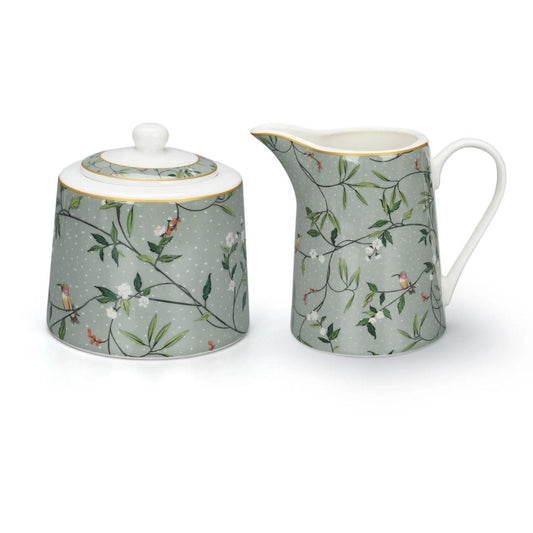 Alice Bell Creamer & Sugar Dish by Mindy Brownes  Add an elegant touch to your tea service with the Mindy Brownes Alice Bell Collection Sugar & Cream Set. Crafted of luxurious ceramic, this set features a cream and sugar dish with an ornate design.