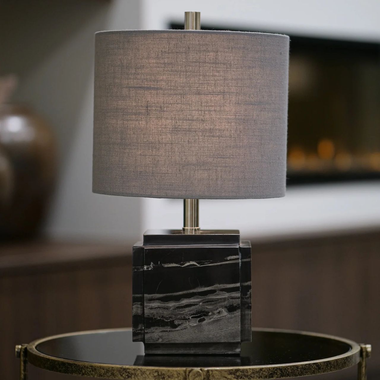 Marble-finished cube base and & drum shaped charcoal shade. Chrome Accents. Sleek & Contemporary in design. Ideal for any room in the home.