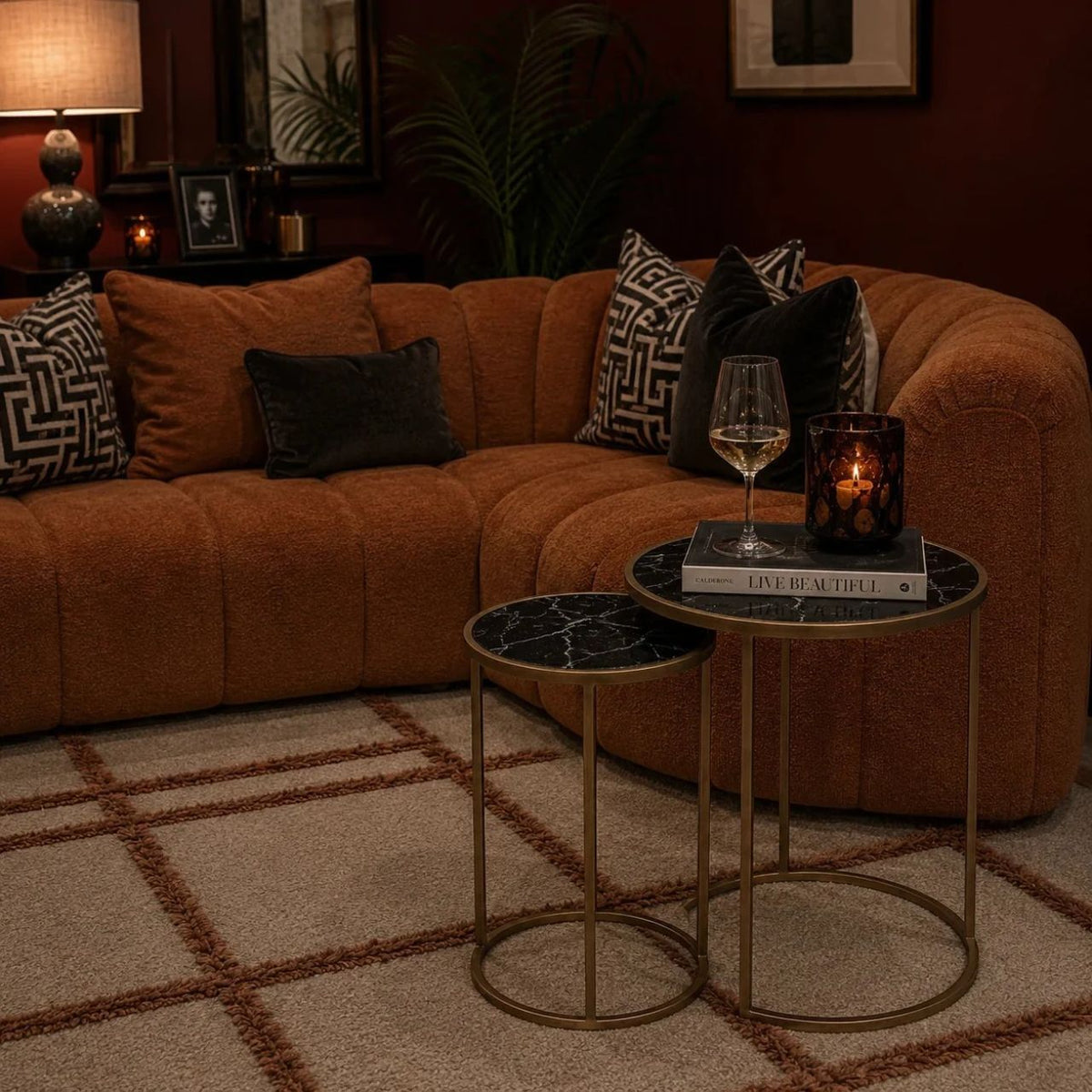 The Arlo Nested Tables in black feature striking marble tops paired with warm metallic frames. The deep tones of the marble add richness and sophistication, while the rounded edges soften the overall look for a balanced, elegant design.