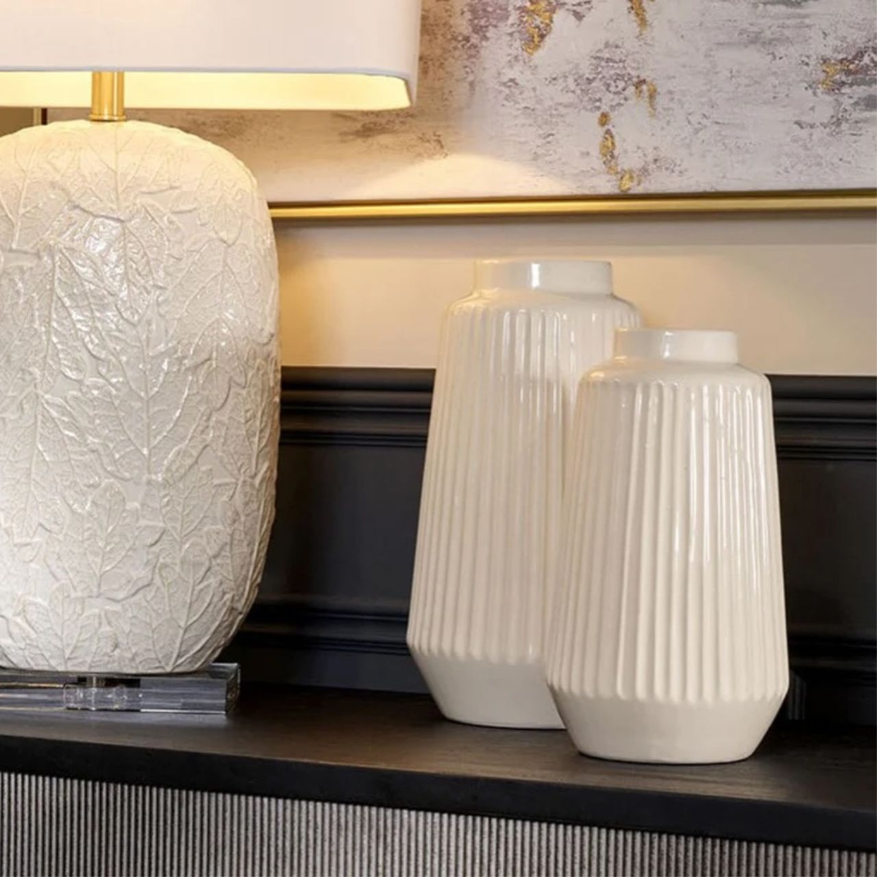 Illuminate your home with our Casla Lamp, featuring a rectangular white crisp shade and leaf pattern base. A truly unique design.