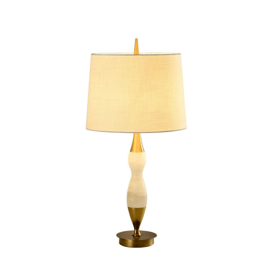 This lamp features white marble, brass accents, and a curved design. Ideal for those of you looking to add some softness to your home.