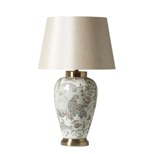 A stunning ceramic lamp with a antique brass base and neutral coloured linen shade. Light blue and white in colour with flower and fauna design.