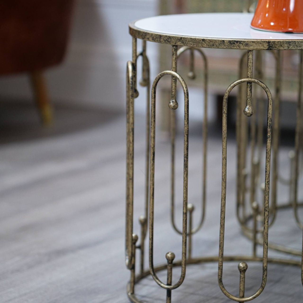 Two is always better than one. A beautiful set of two side tables that neatly stack on top of each other. Circular in design with oblong detailing on the outer surround. Finished with a mirrored top and distressed antique gold.