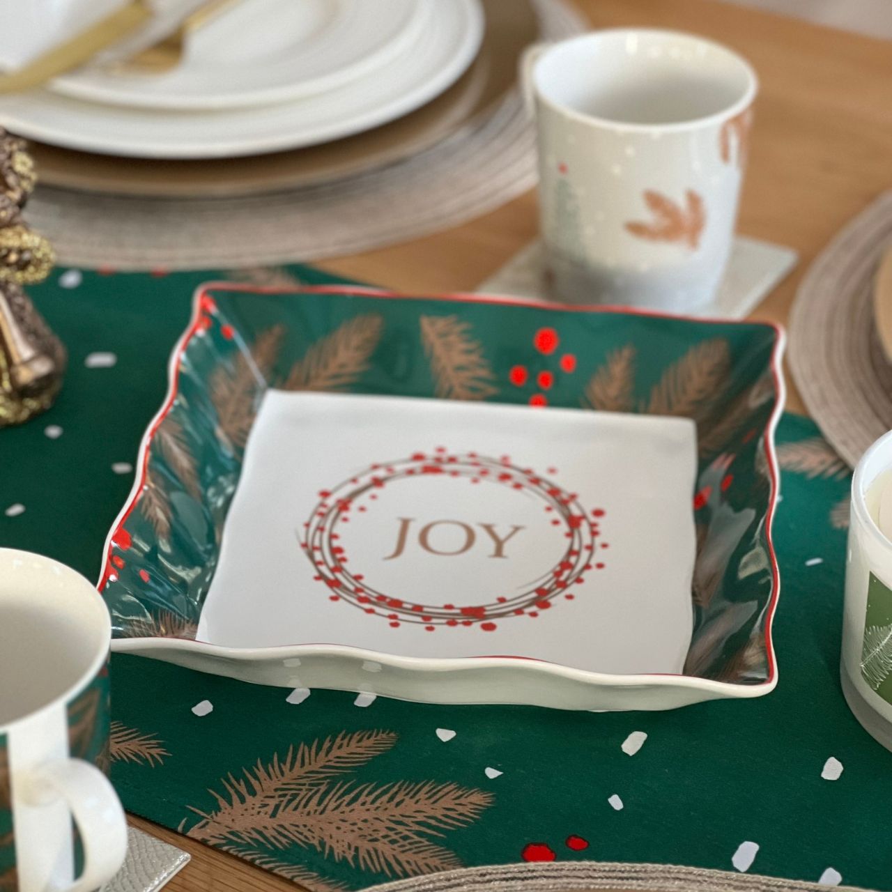 Christmas Festive Fir Serving Dish by Mindy Brownes Interiors  Introducing our Festive Fir collection. This charming collection is adorned with beautiful designs inspired by Christmas fir branches, red berries, and heartwarming holiday messages on green and white backgrounds.